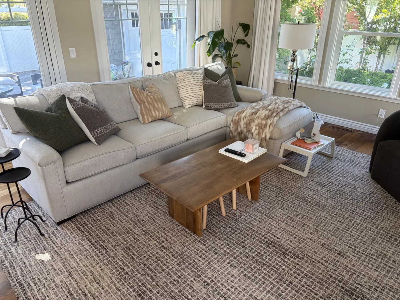 Bright living room sofa and rug reset after residential house cleaning by Sun Ray Cleaning Services